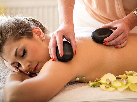 Lady receiving Hot Stone Massage at Asian Massage Therapy Des Moines IA   call 515-305-9139