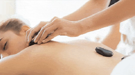 Picture of Lady getting shoulder massage with a Hot Stone. Feels so good!
